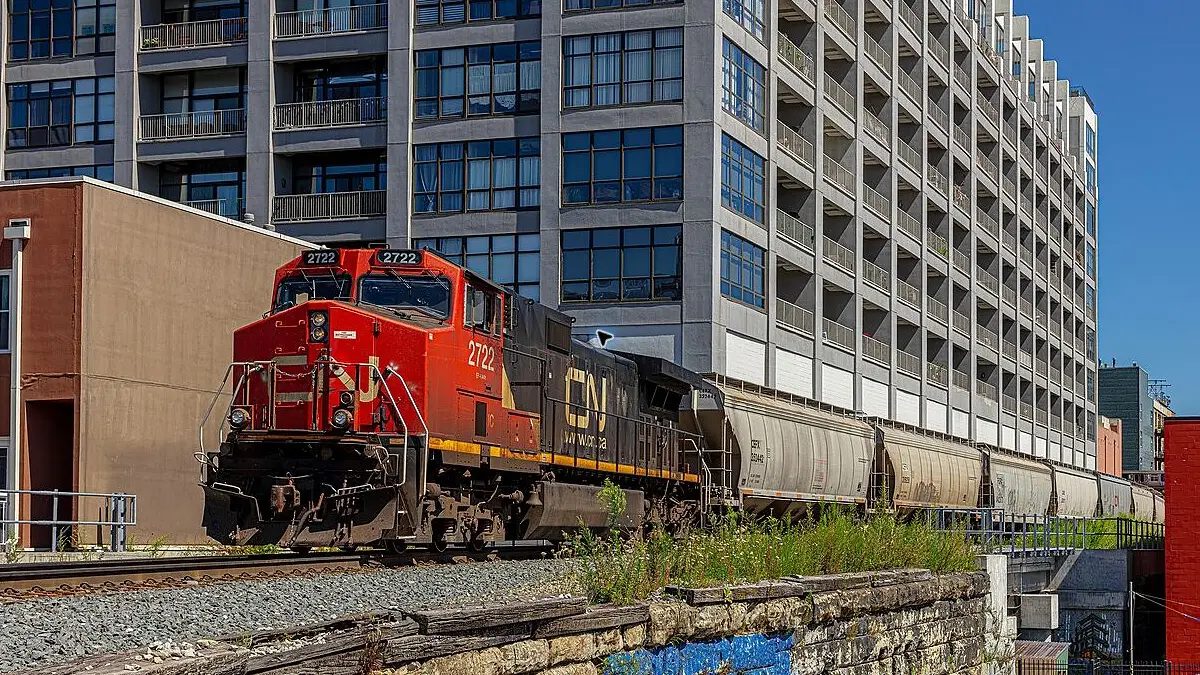 CN grain train with covered hopper cars moving through Chicago