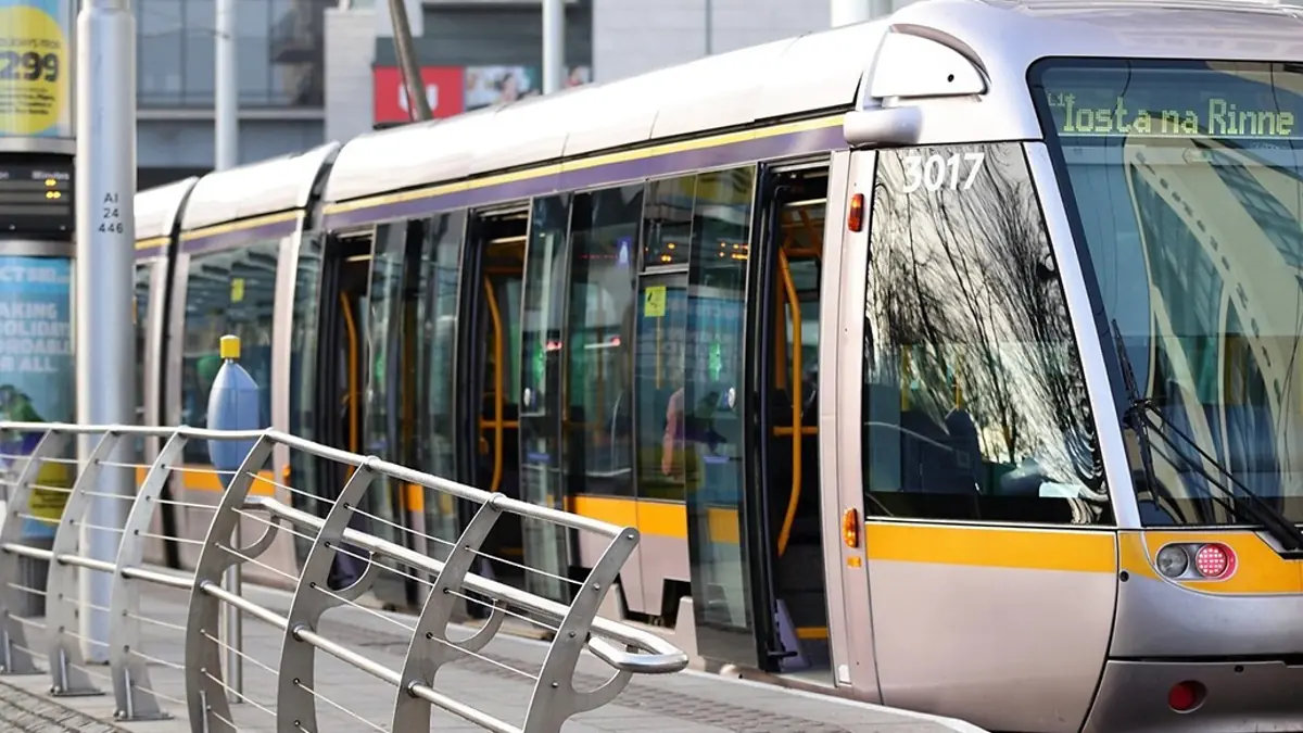 Silver Luas tram standing at a stop in Dublin