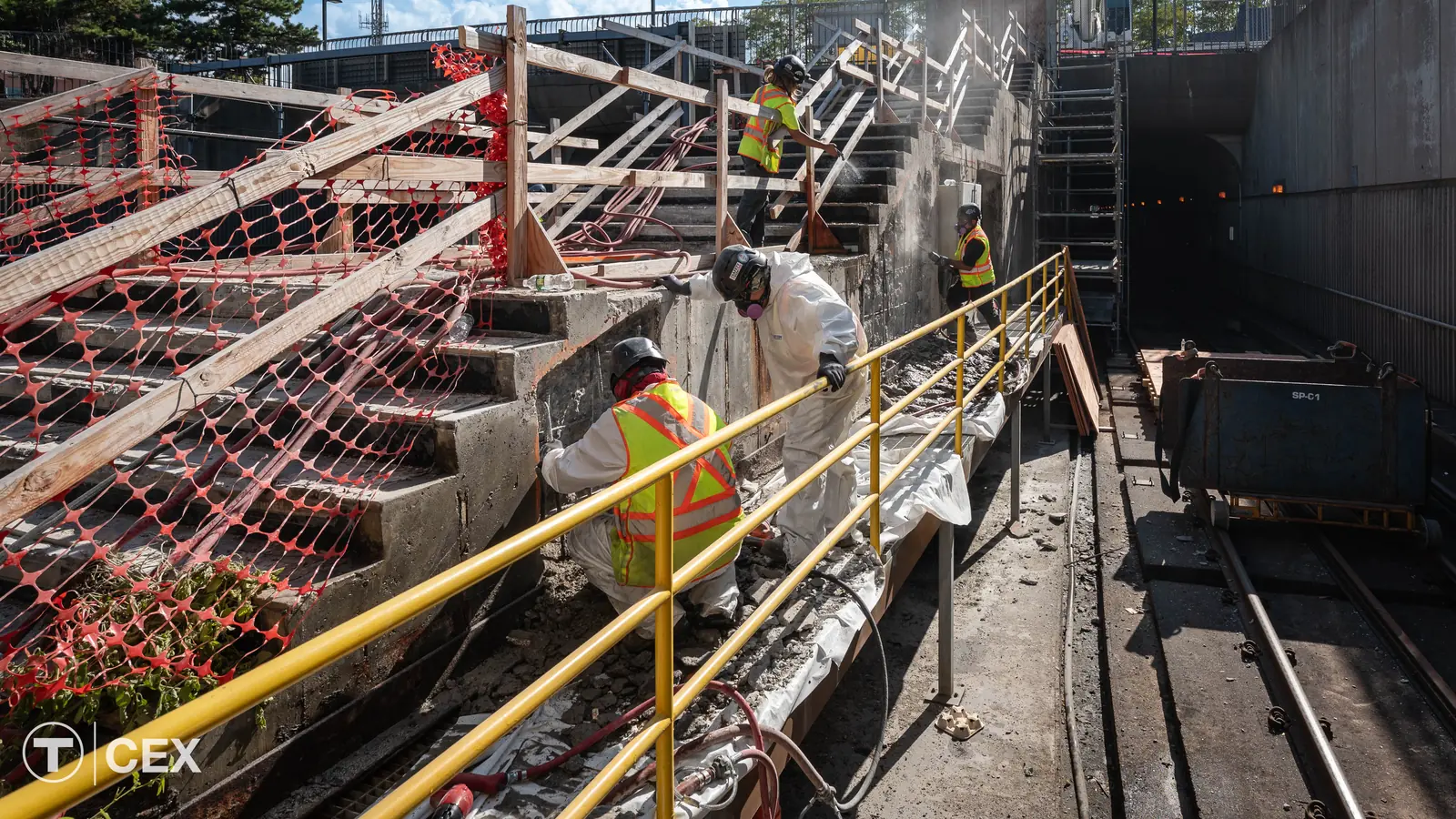 Crews remove concrete beside an exit-only stairway at Ruggles StationTitle: Concrete repairs at Ruggles Station