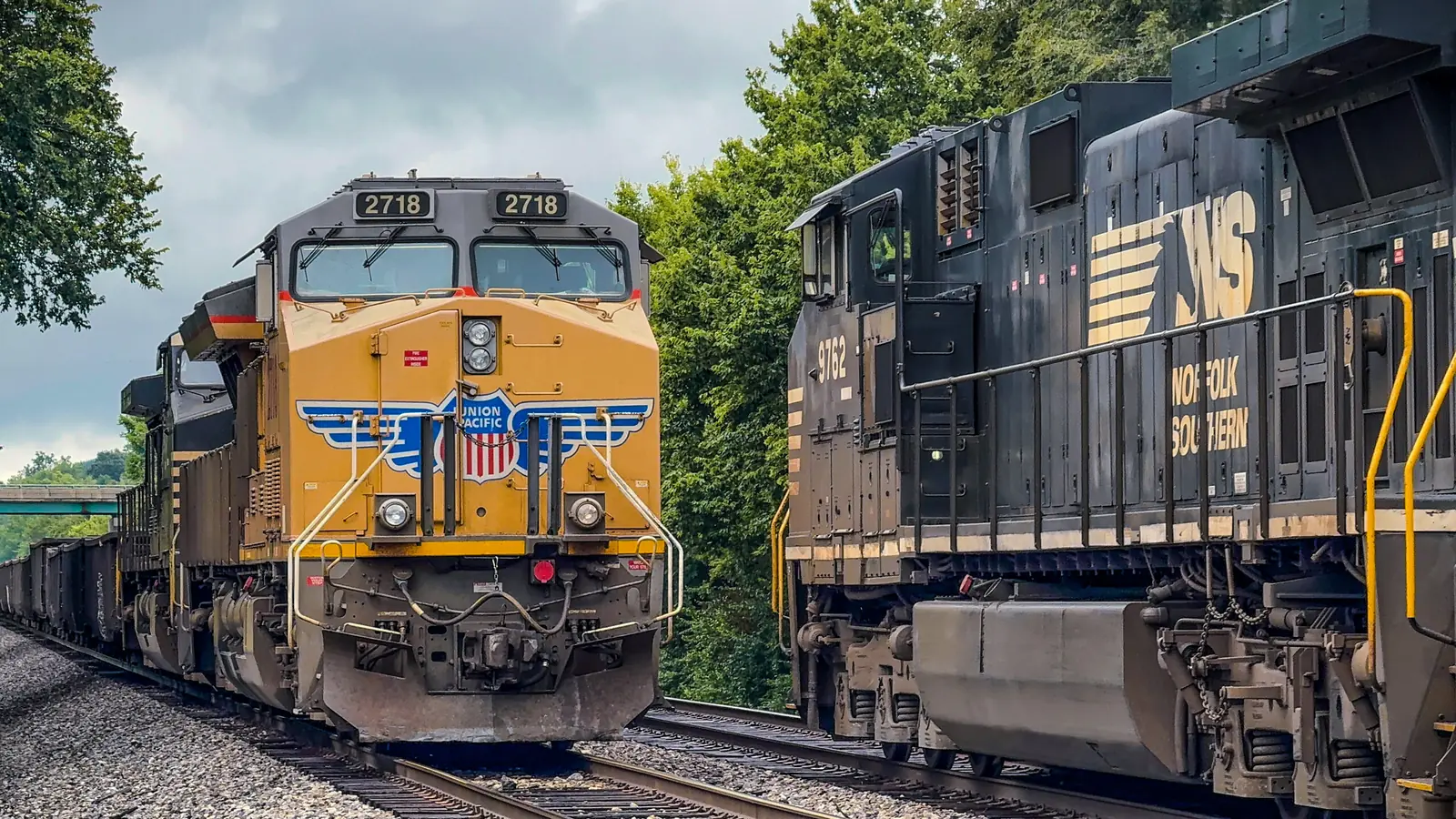 Union Pacific locomotive 2718 passes Norfolk Southern locomotive 9762 on parallel tracks