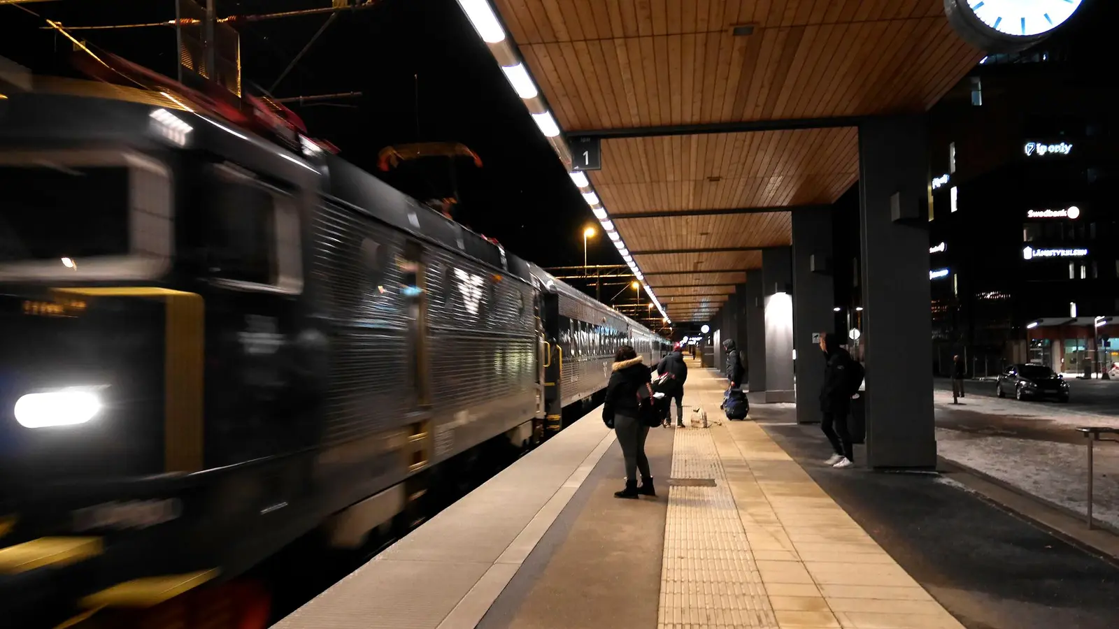 SJ night train beside a station platform at night