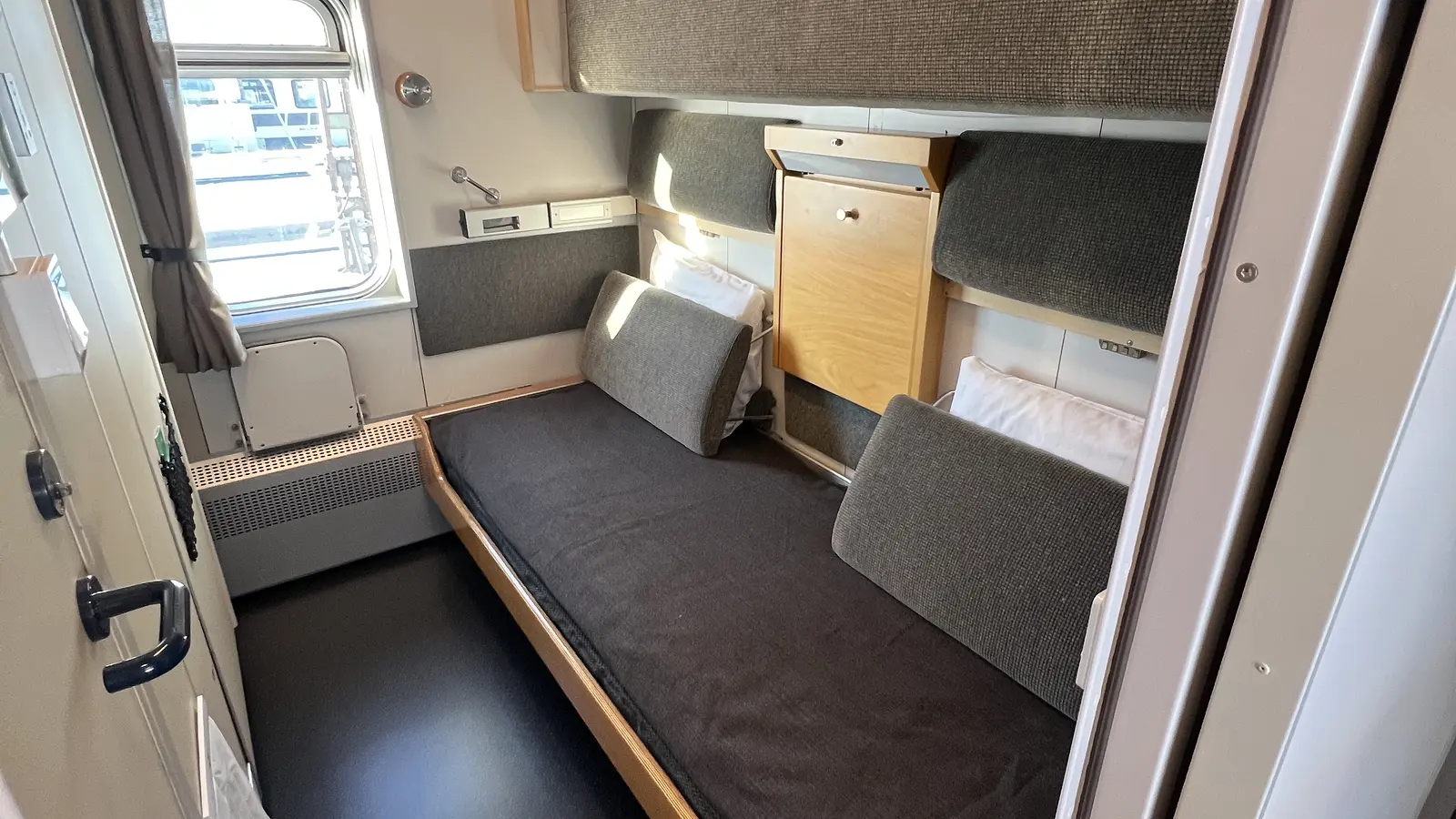 Refurbished SJ sleeping compartment with a lower berth and folded upper berth