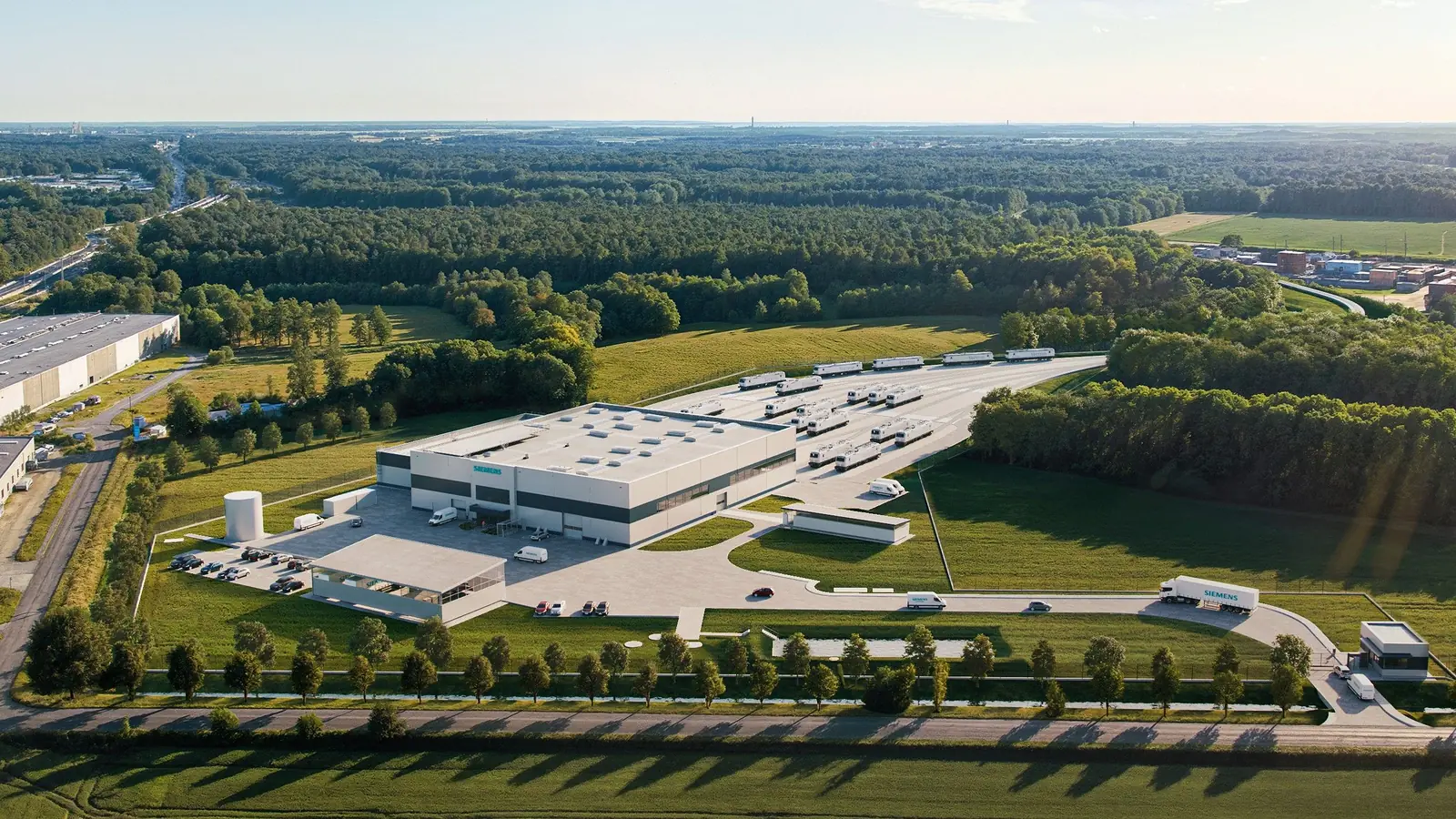 Site rendering of the planned Siemens depot at Gądki, viewed across the surrounding fields