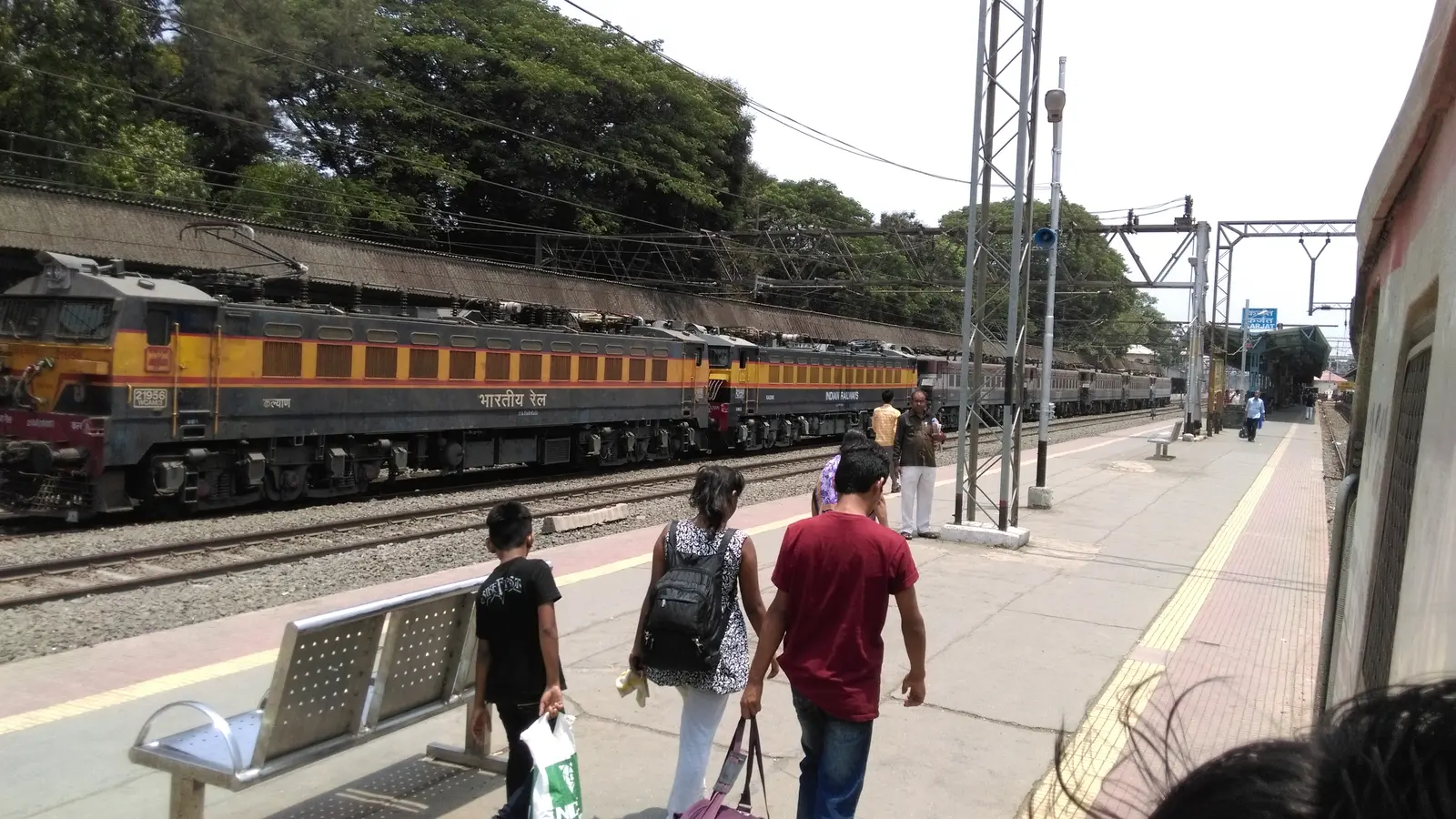WCAM-3 electric locomotives beside a passenger platform at Karjat railway station