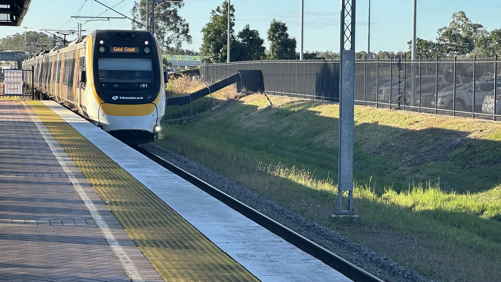 Queensland Rail train approaching the platform at Helensvale station