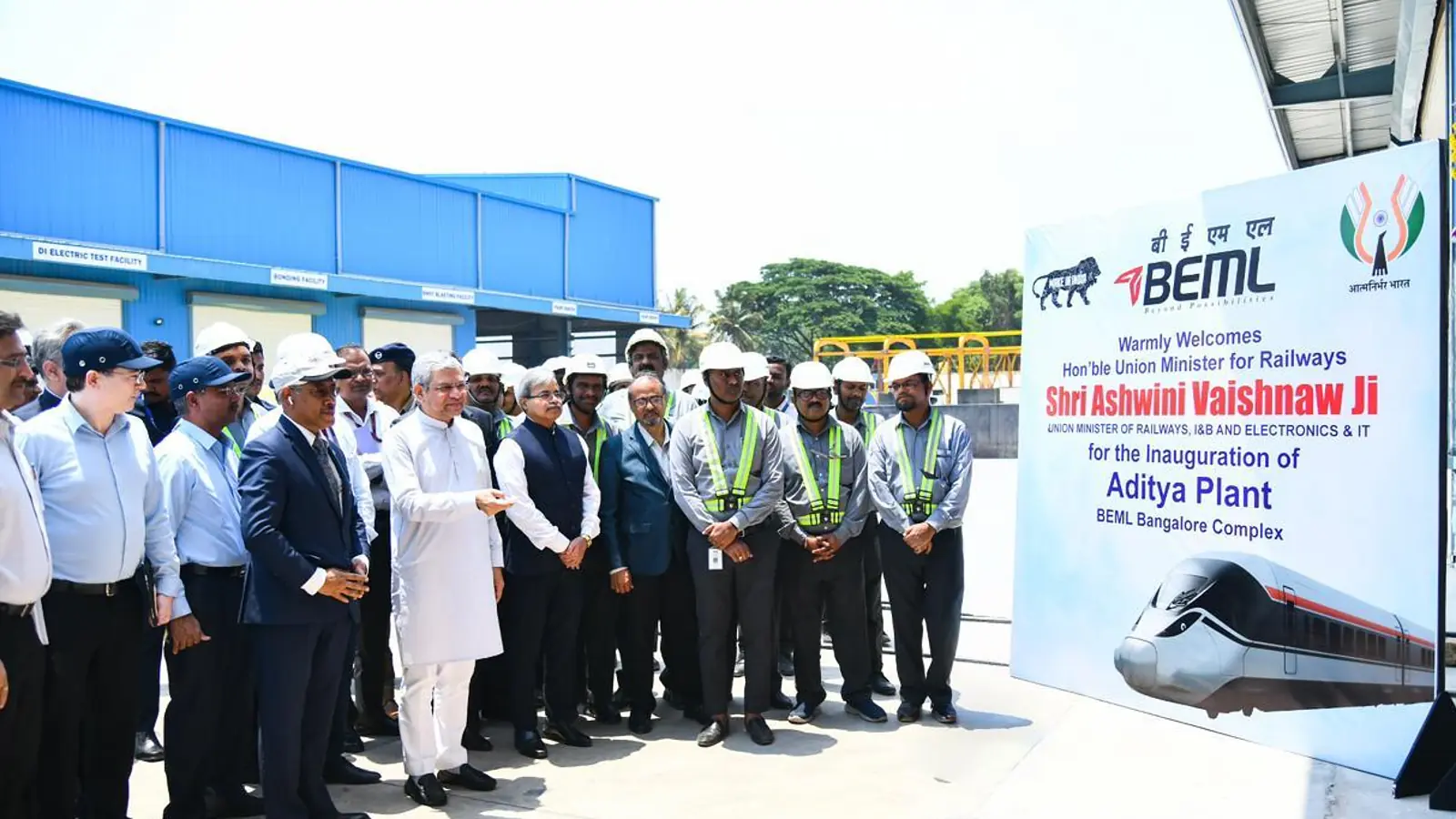Officials at BEML’s Aditya rail complex beside a display of the B28 high-speed train