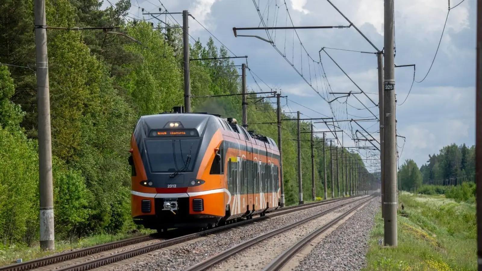 Elron passenger train on an electrified railway near Kehra, Estonia