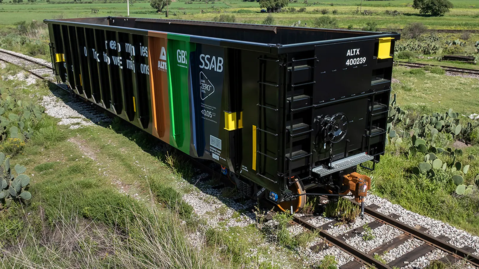 Greenbrier gondola with GBX, Alter and SSAB markings on track