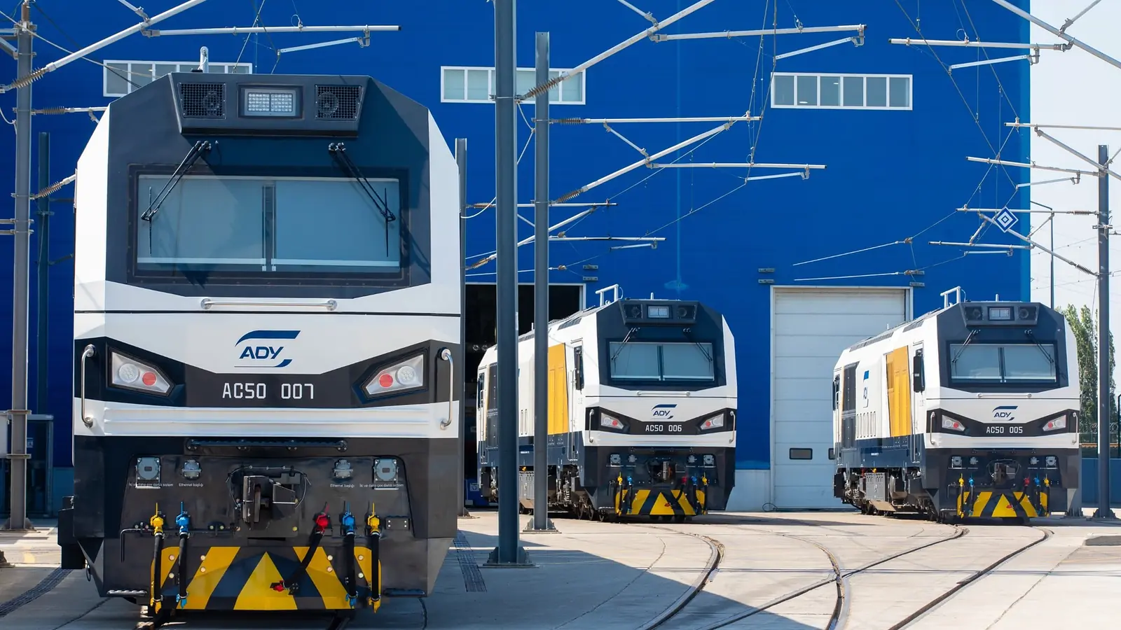 Three Azerbaijan Railways AC50 freight locomotives lined up at a Baku depot