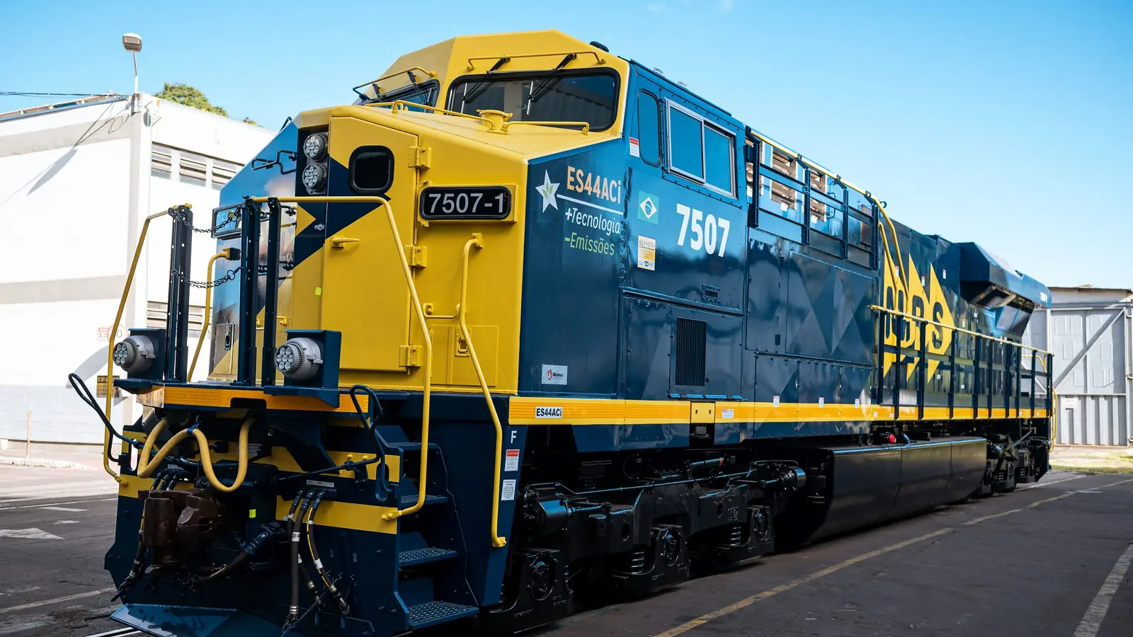 Blue-and-yellow MRS ES44ACi locomotive viewed from the front and side