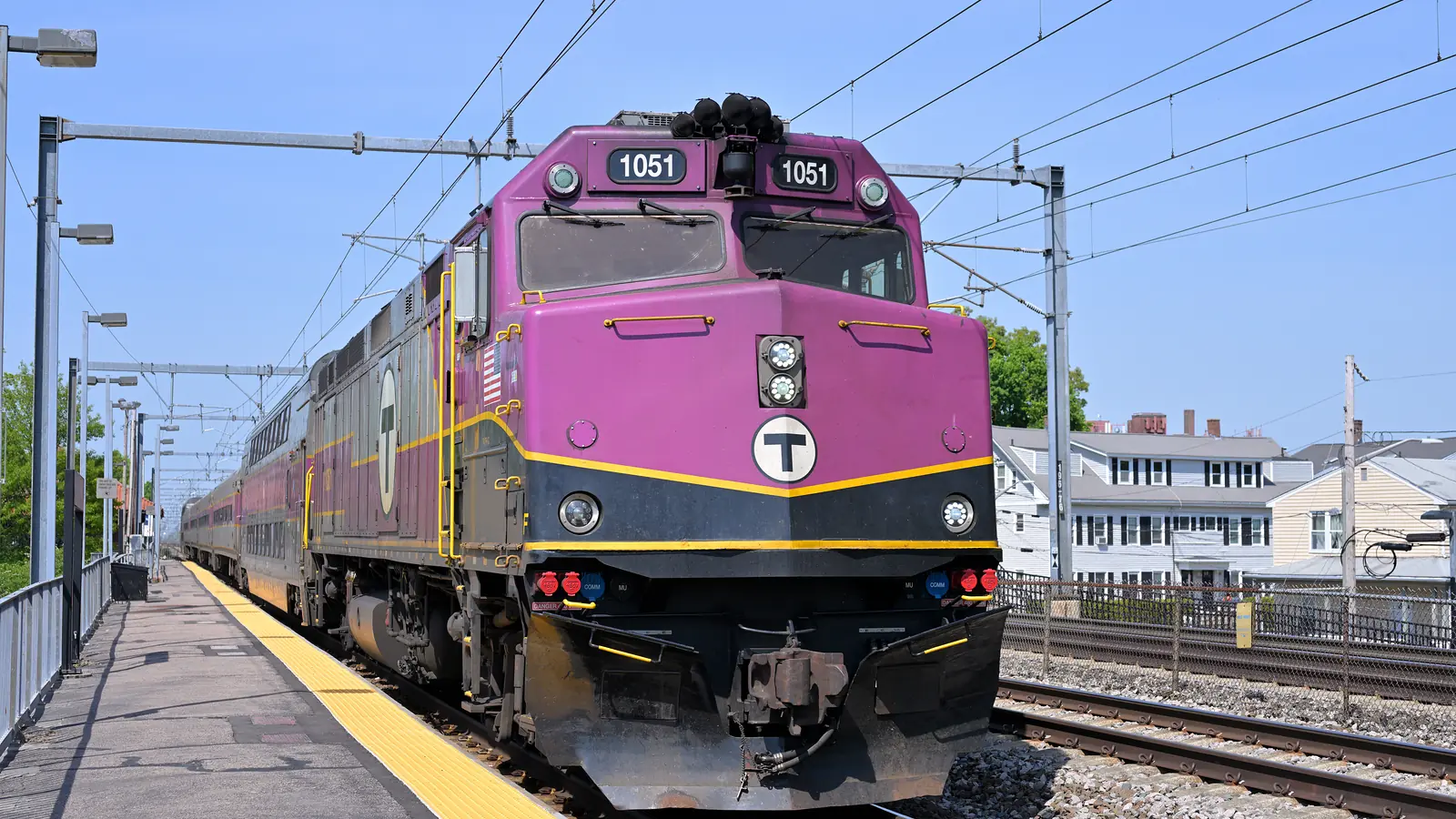 MBTA commuter rail locomotive 1051 arrives at Attleboro station beneath catenary wires