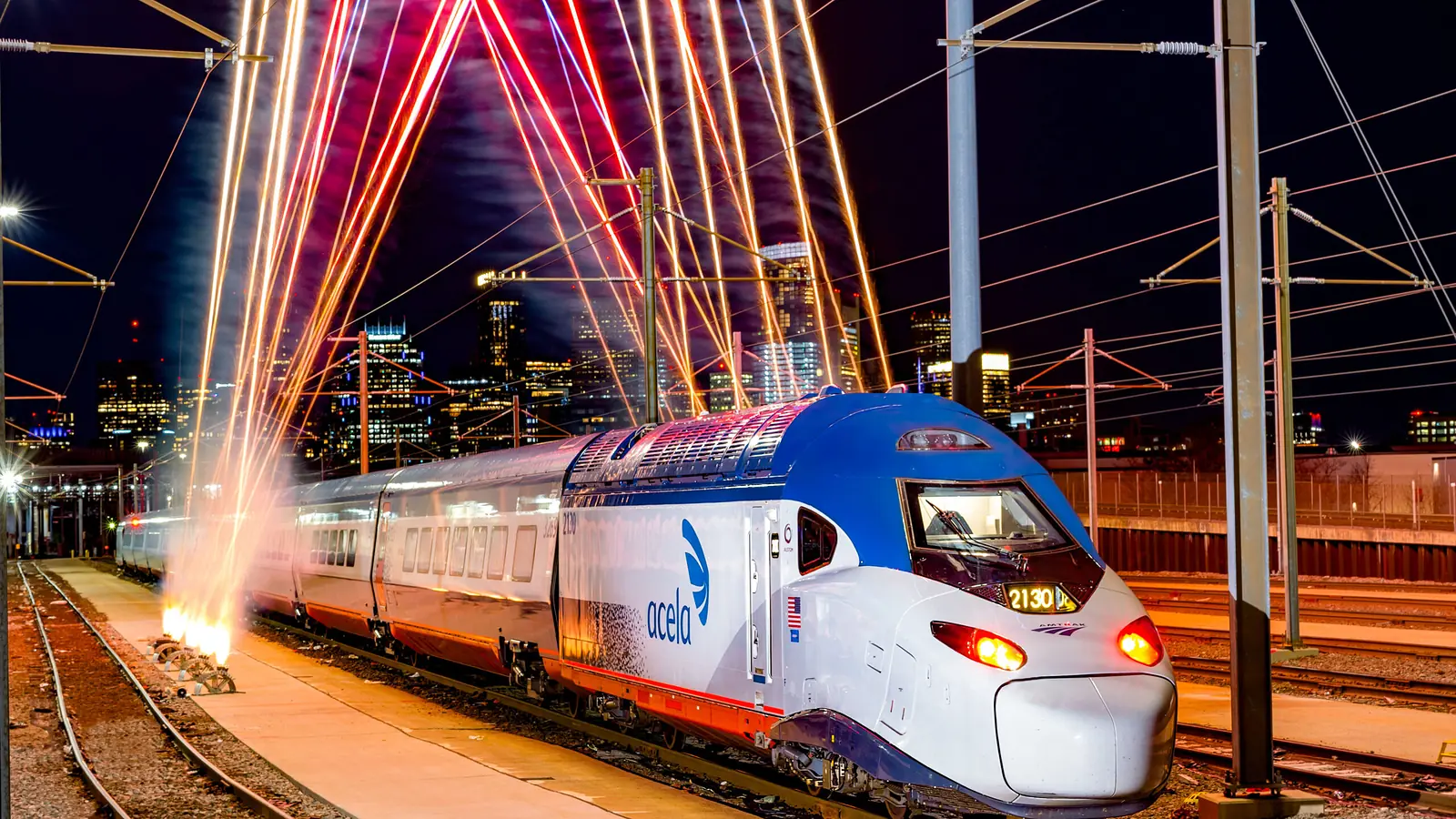 NextGen Acela trainset beneath illuminated bridge arches at night