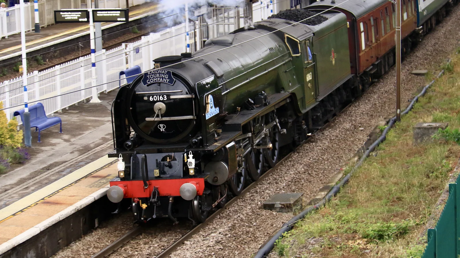 Close view of steam locomotive 60163 Tornado passing Oakleigh Park station