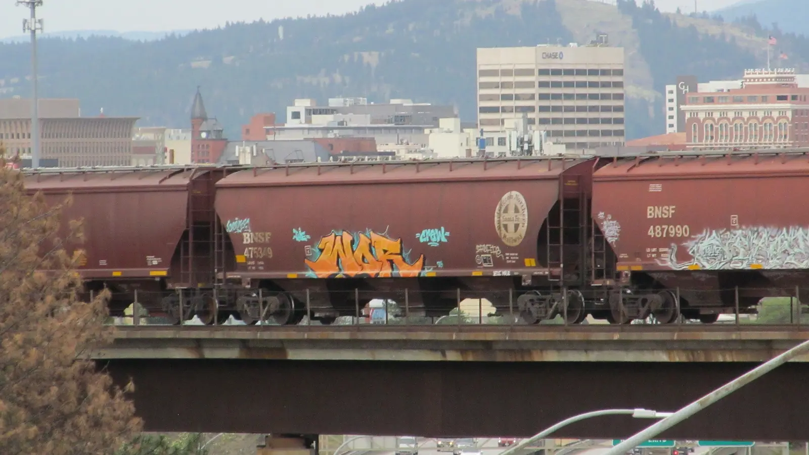     BNSF covered hopper cars crossing Interstate 90 in Spokane, Washington