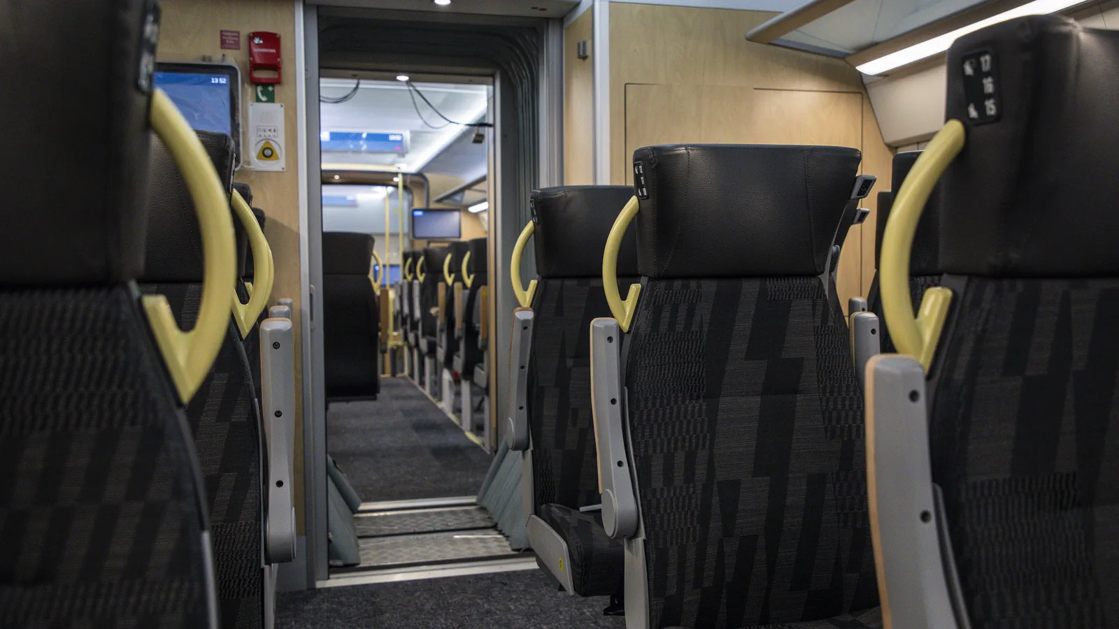 Passenger seats and central aisle inside a Västtrafik Alstom X80 train